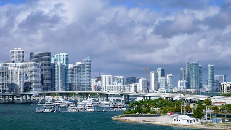 Photograph of Miami, Florida skyline with bridge and boats in the foreground