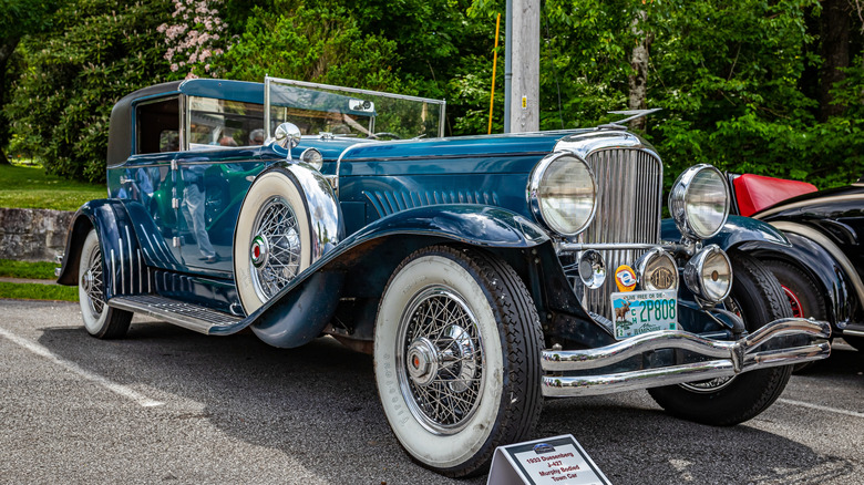 A blue Duesenberg Model J parked