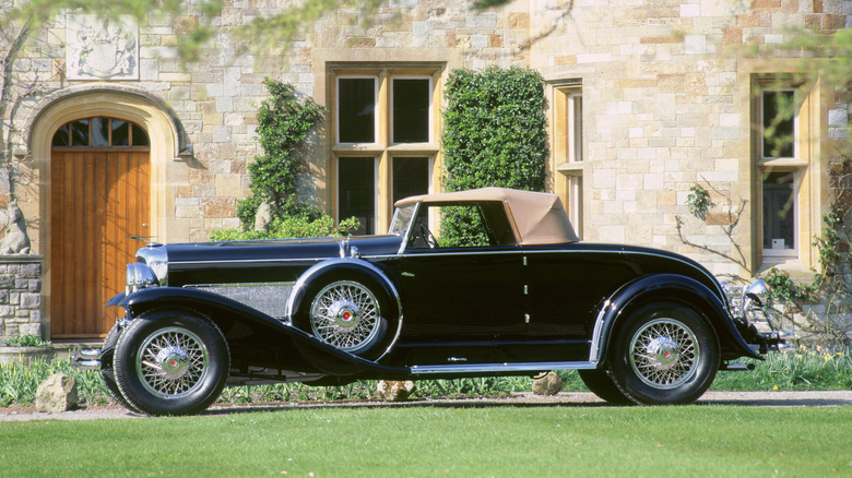 A black Duesenberg Model SJ parked