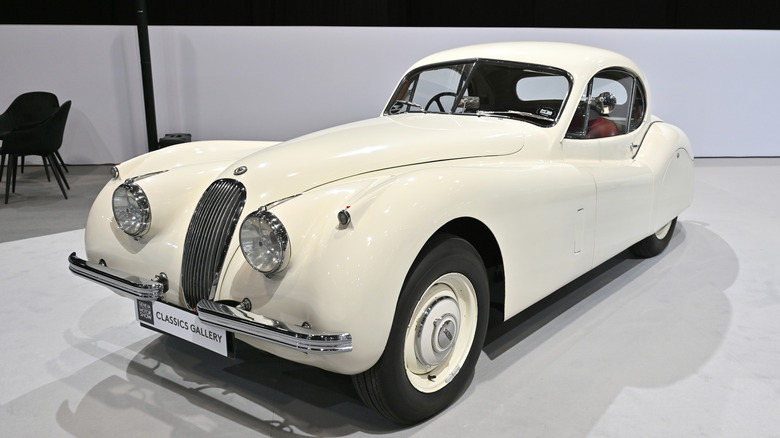 A white Jaguar X120 in a museum