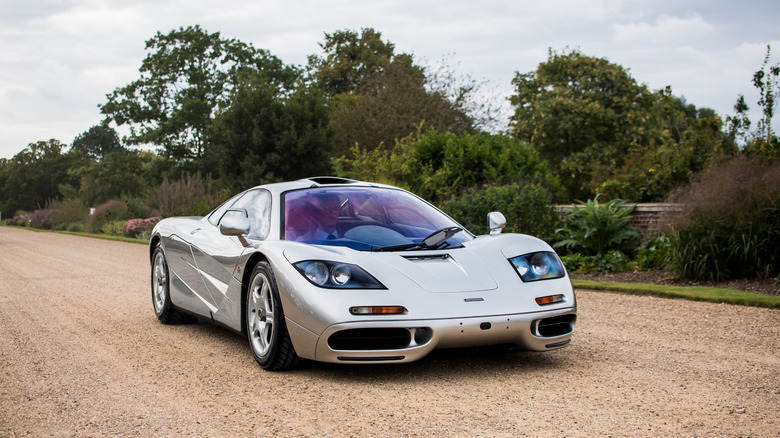 A silver McLaren F1 driving