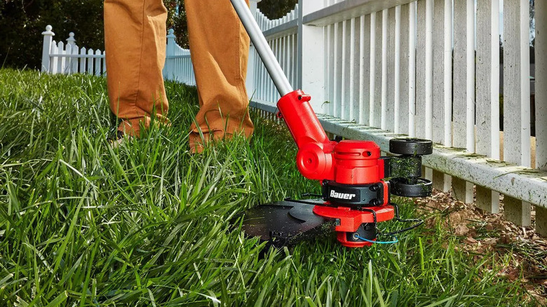 Bauer weed eater trimming grass