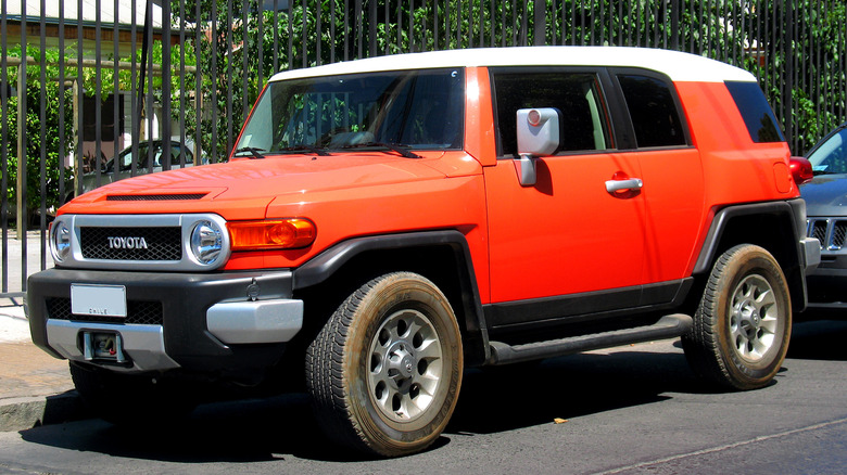 An orange 2013 Toyota FJ Cruiser Limited parked