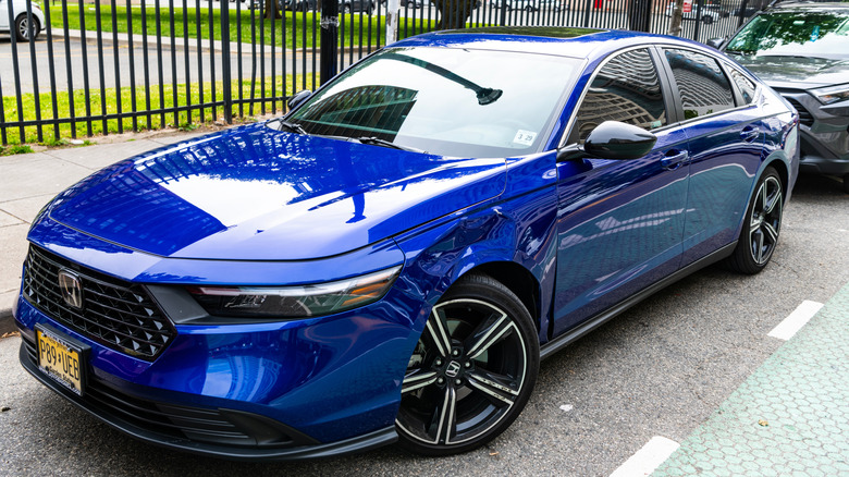 A blue 2025 Honda Accord parked at the side of a street.