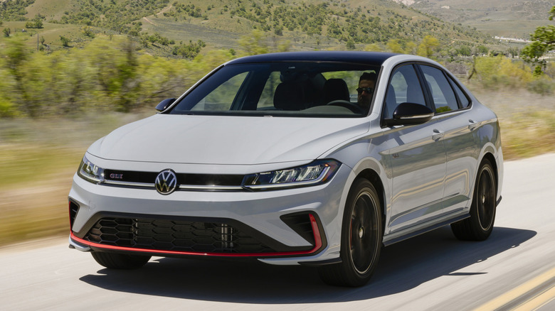 Front 3/4 view of Volkswagen Jetta GLI on road in mountainous setting