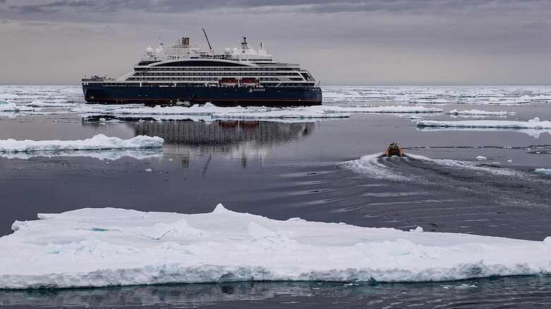 French Vessel Le Commandant Charcot transits an ice field while the crew of French Navy Vessel Rhone conducts small boat operations June 23, 2024.