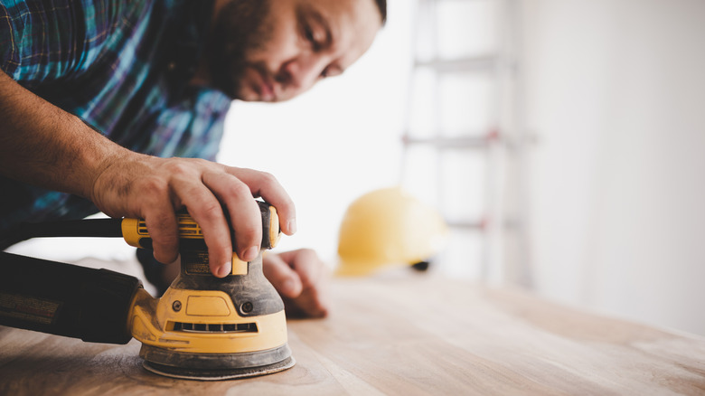 woodworker using a sander