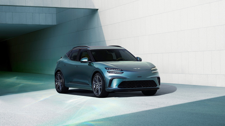 A front end shot of a blue Genesis GV60