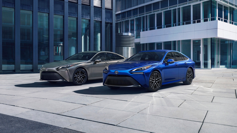 A side on shot of two Toyota Mirai sedans in blue and gray