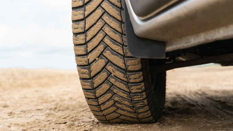 A close up of a tire covered in dirt