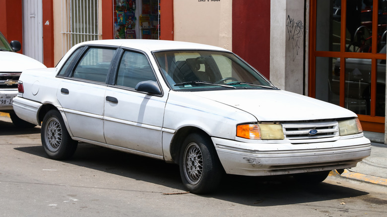 White Ford Tempo parked on street