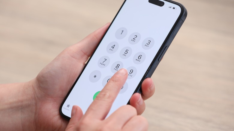 Person dialing a number on a cellphone