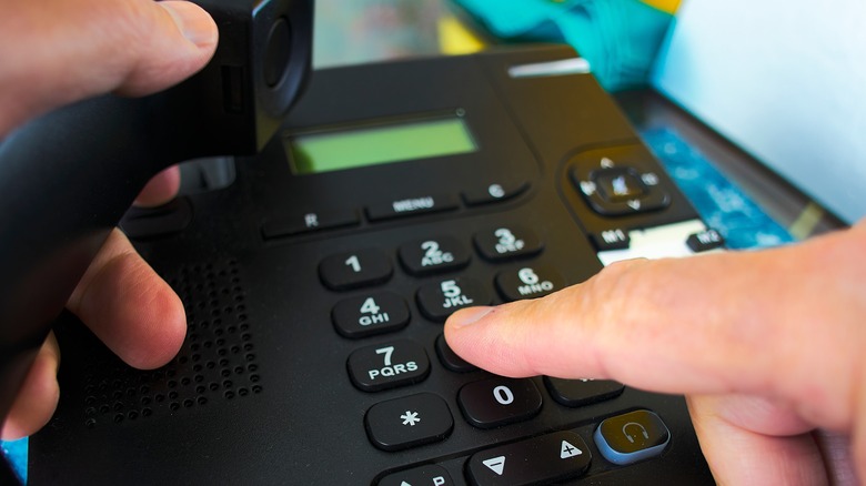 Man using landline telephone