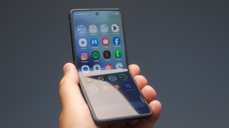 A hand holding a foldable phone.