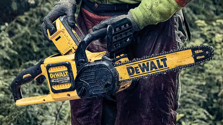 Worker holding DeWalt chainsaw