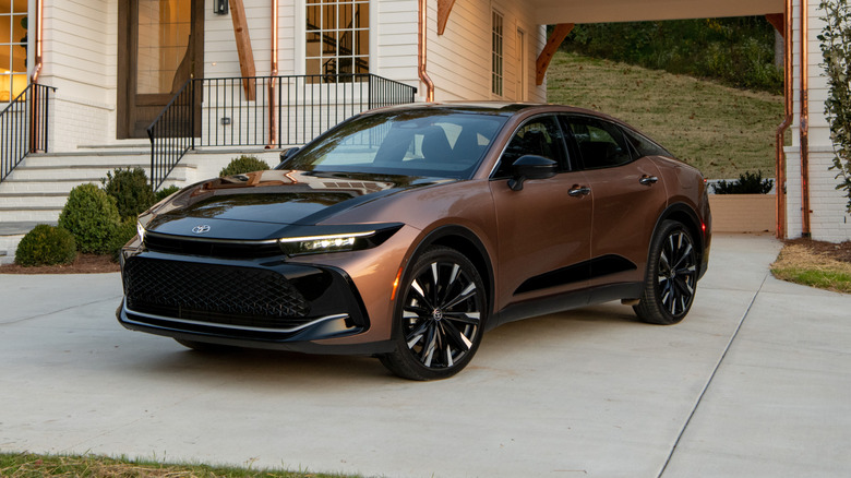 A two-tone 2026 Toyota Crown parked in front of a residential building.