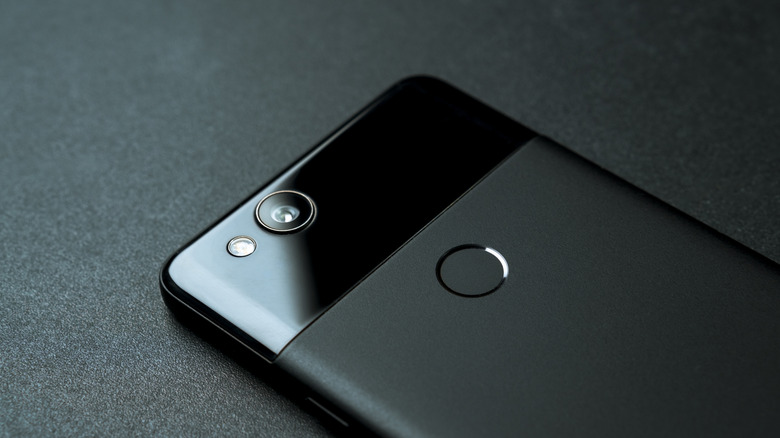 Black Google Pixel 2 face-down on a black surface.