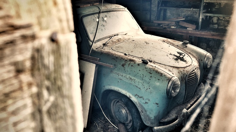 british car abandoned in barn