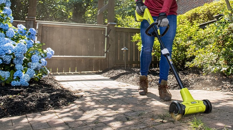 Woman using edger tool