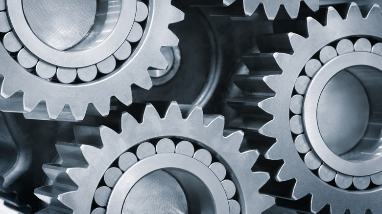 A close-up shot of three gears with a lot of teeth