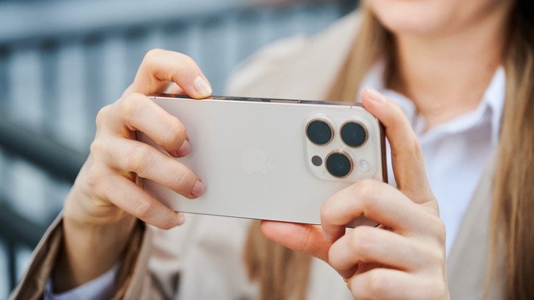 Person clicking photo with an iPhone.