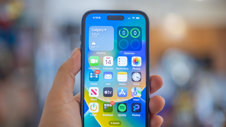 A hand holding an iPhone 15 Plus