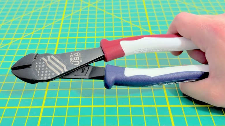 Close-up of person holding Klein Tools 250th Edition Diagonal Cutting Pliers