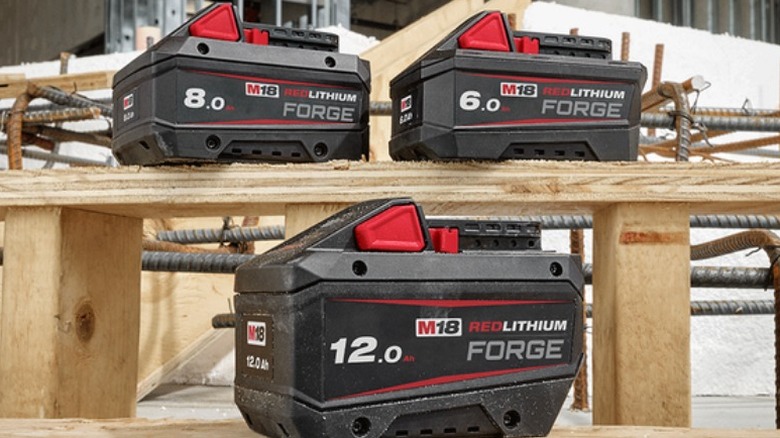 Milwaukee M18 batteries on plywood shelves