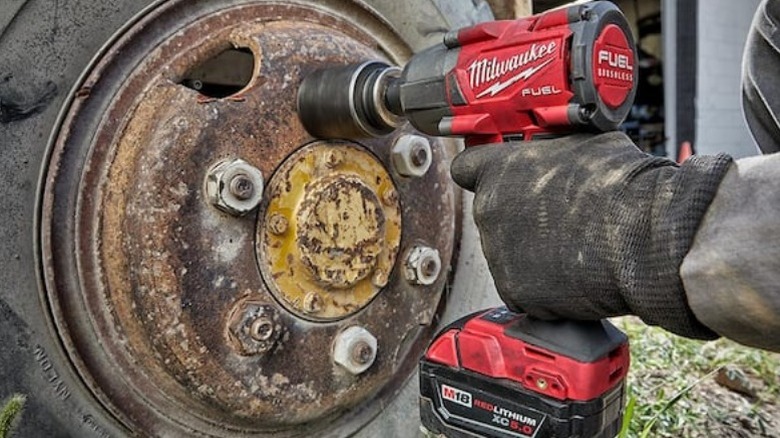 Person using M18 Fuel Brushless Cordless ½-inch Impact Wrench on tire