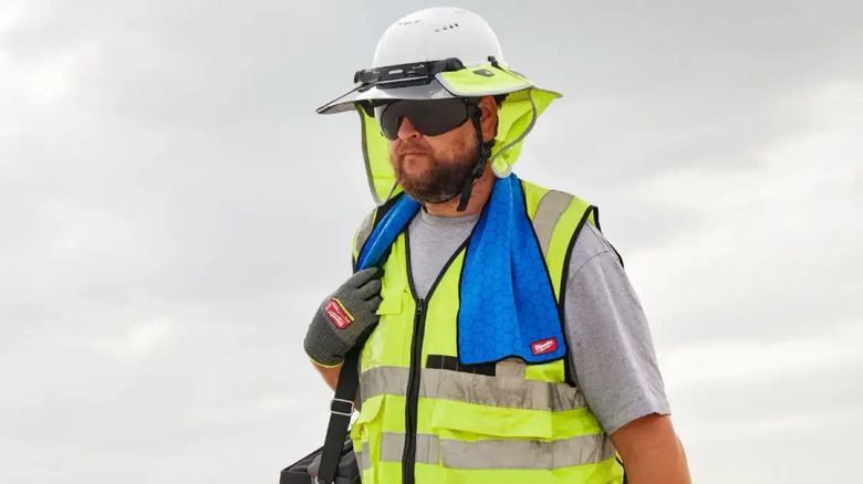 Man at job site with cooling towel 