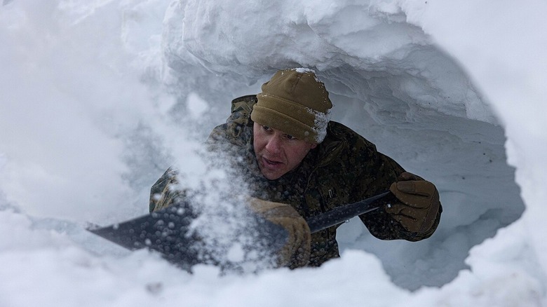 U.S. Marine Corps 1st Lt. Jacob Ballard builds a snow-cave shelter during cold-weather training for Exercise Nordic Response 24 at Setermoen, Norway, in 2024.