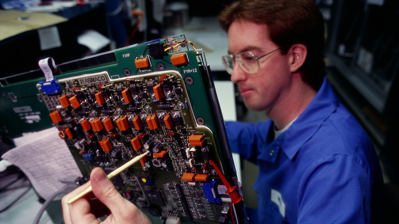 Technician at plasmaco electronics builds a monitor