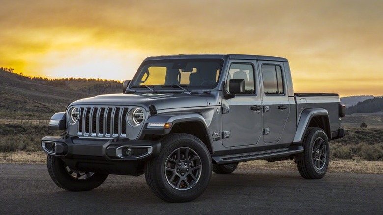 Silver 2020 Jeep Gladiator parked on a rural road at sunset
