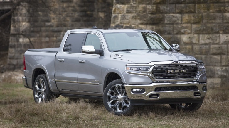 Silver 2019 Ram 1500 parked on grass in front of bridge columns