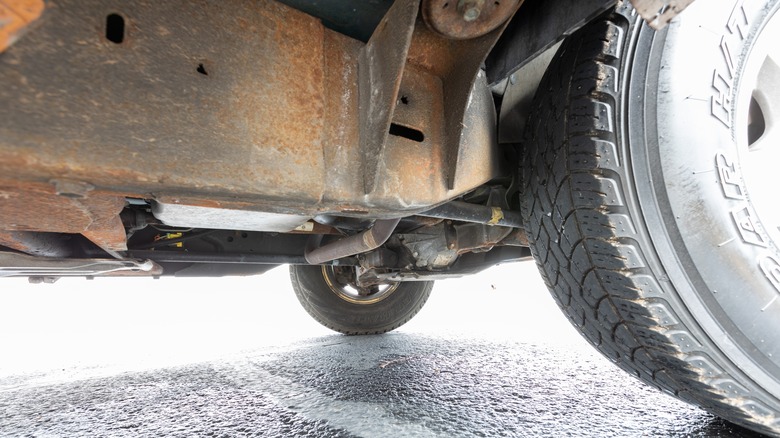 Rusty underbody frame of a '90s Chevrolet Silverado pickup truck