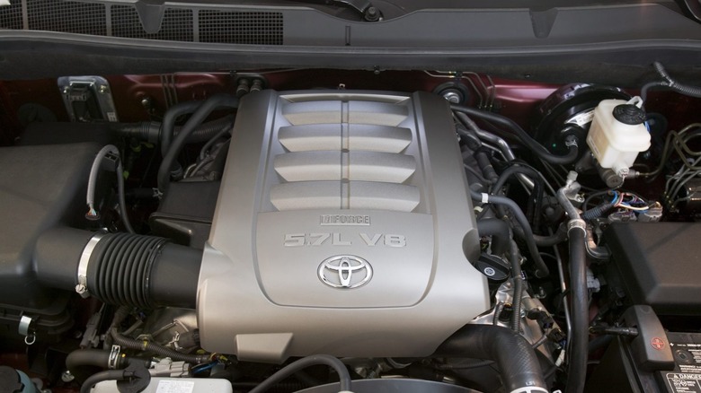A black and gray Toyota 3UR-FE 5.7-liter i-Force V8 engine in a 2008 Toyota Tundra, showing the factory engine cover.
