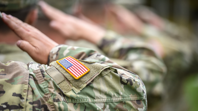 Close-up of American flag on saluting soldier's uniform