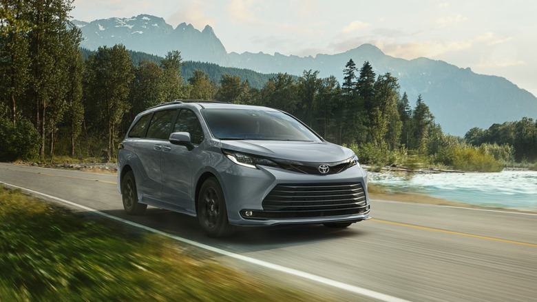 2026 Toyota Sienna Woodland driving through forested road, front-right view