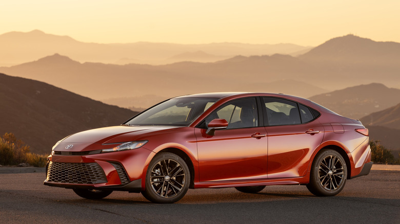 2026 Toyota Camry SE parked with mountain backdrop, left-side view