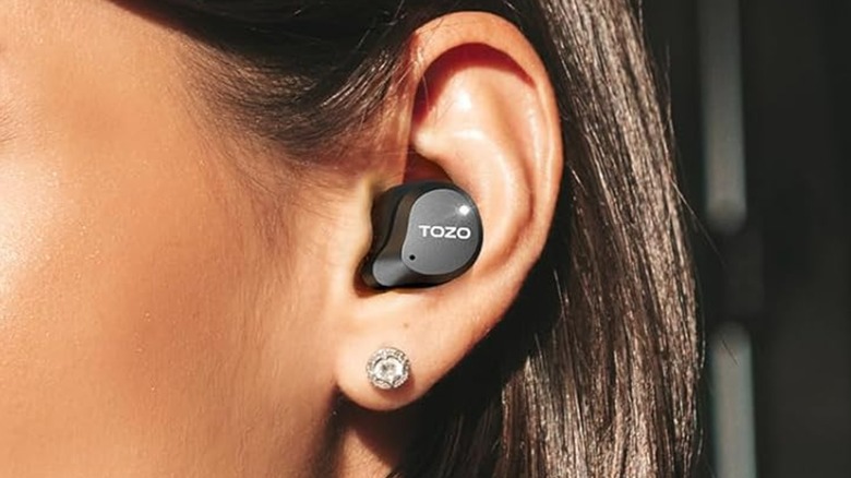 A person wearing a Tozo earbud.