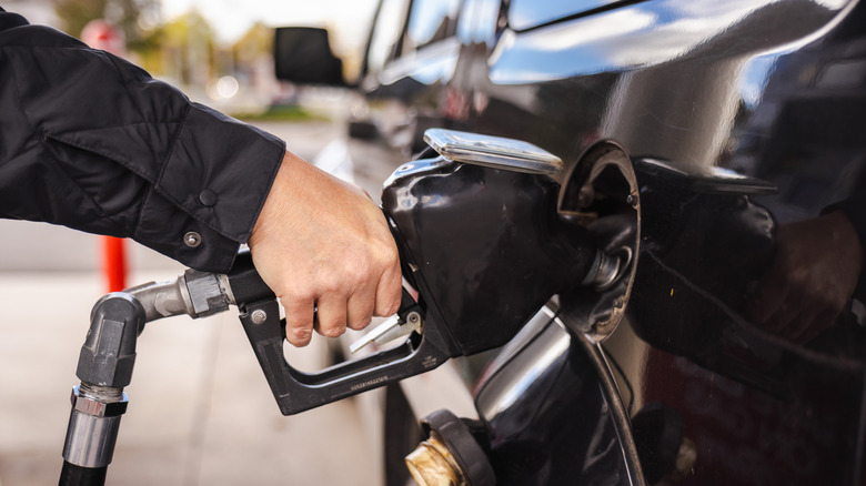 Person refueling a car