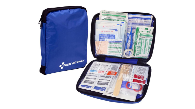 A blue bag carrying a first aid kit by First Aid Only.