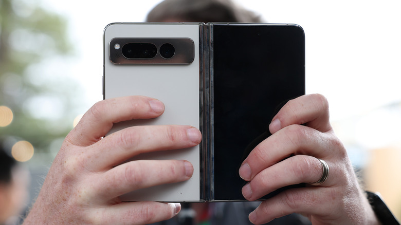 A member of the media inspects the new Google Pixel Fold