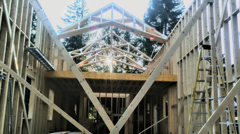 A home being built, trees in the background.
