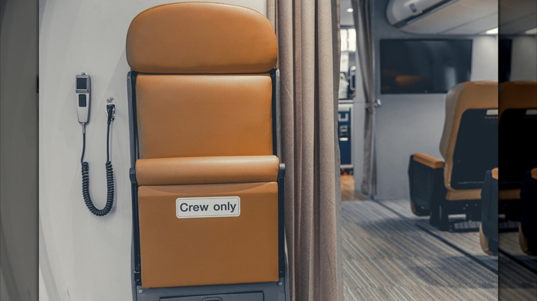 A cabin crew dedicated seat in an aircraft