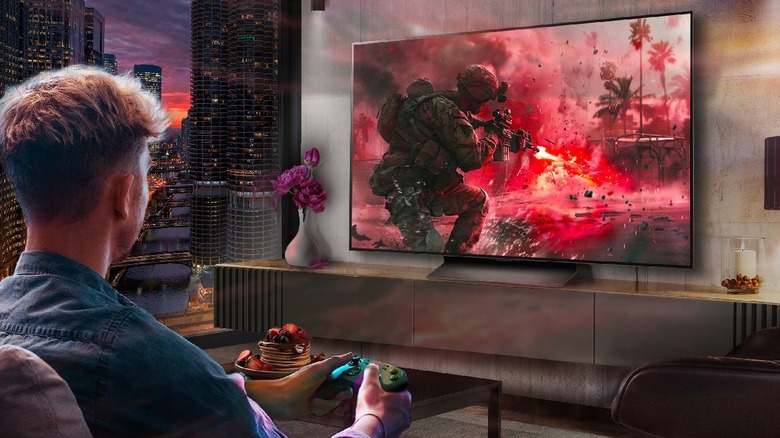 A man plays a game on an LG OLED TV