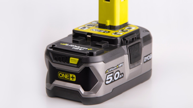 A Ryobi battery on a white backdrop.