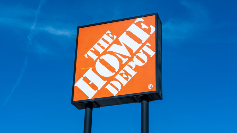 A Home Depot sign against a blue sky.