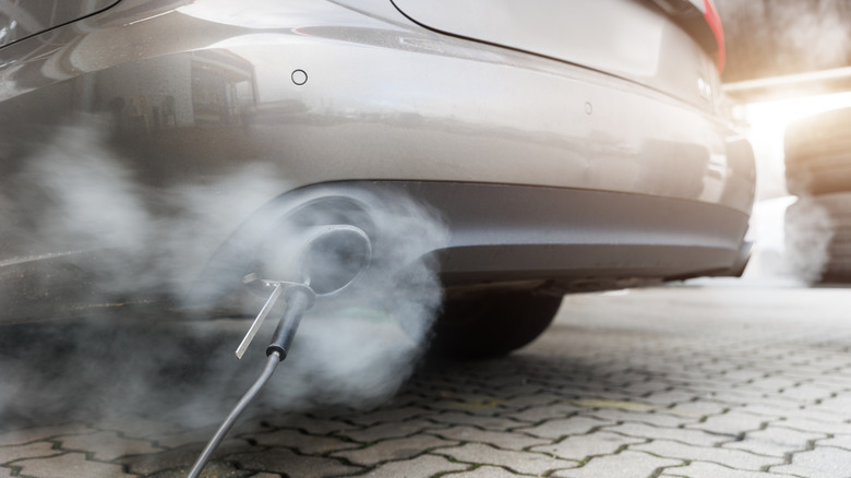 A close-up of a car's exhaust system while being emissions tested.