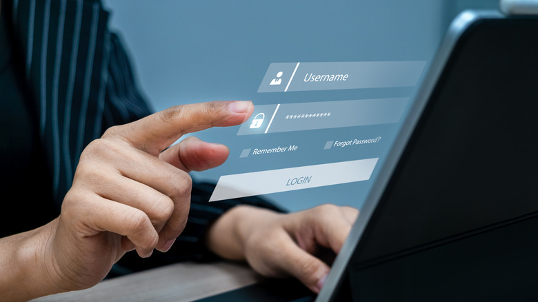 Man entering password on laptop